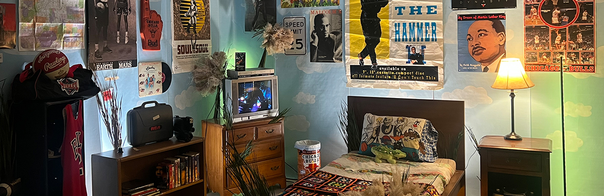 A recreated childhood bedroom, including MC Hammer, Martin Luther King Jr., Chicago Bulls, and Malcom X posters on the wall.
