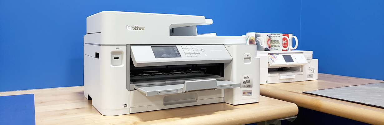 Inkjet printer sitting on a work station inside the Creative Studio.