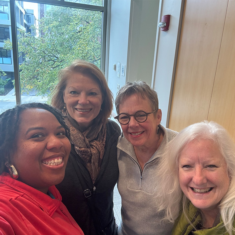 Yoga teacher DuShaun Branch taking a selfie at the library with three of her students.