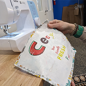 Fabric being sewn by machine.