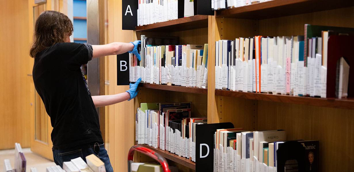 Library staff person shelving materials.